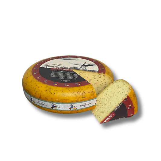 Round cheese with a slice removed, featuring a decorative label on a white background