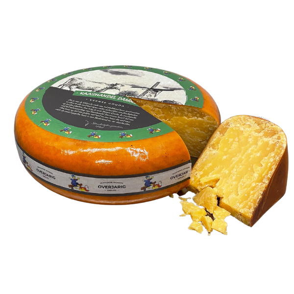 Round cheese with a slice removed, featuring a decorative label on a white background