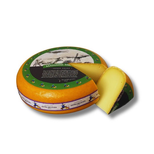 Round cheese with a slice removed, featuring a decorative label on a white background