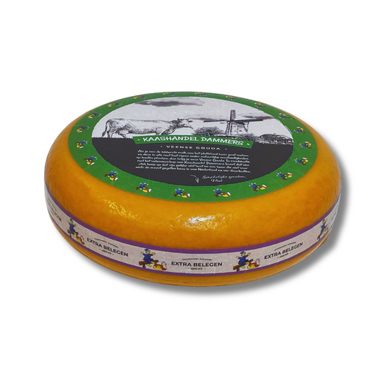 Round cheese wheel with decorative label on a white background