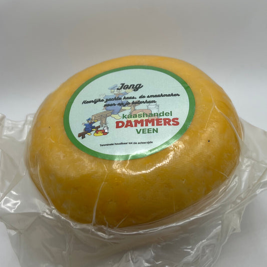 Yellow cheese wheel with a label on a white background