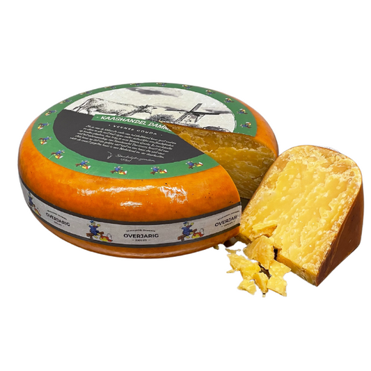 Round cheese with a slice removed, featuring a decorative label on a white background